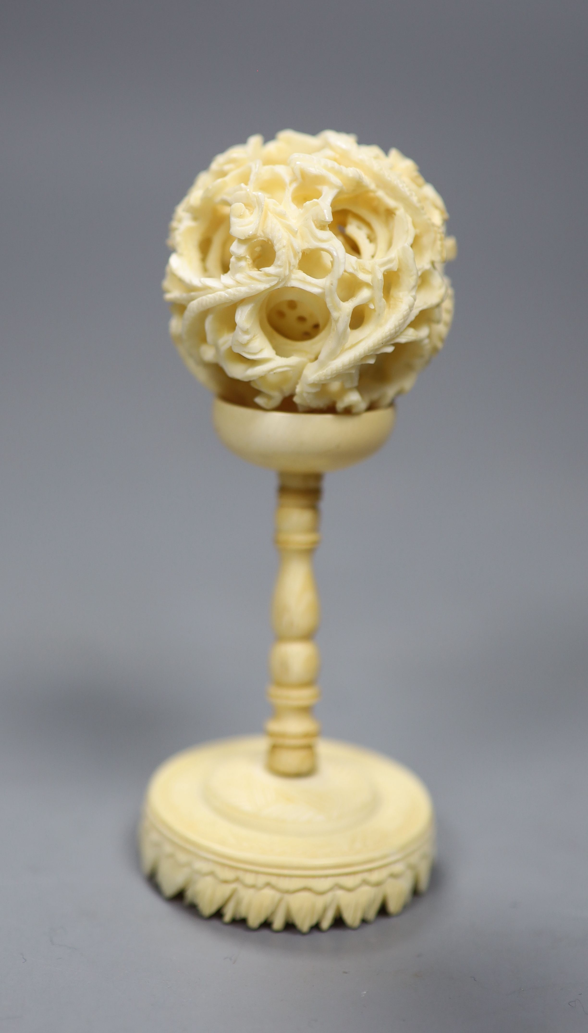 A carved Chinese ivory ball on stand, early 20th century, height 10.5cm